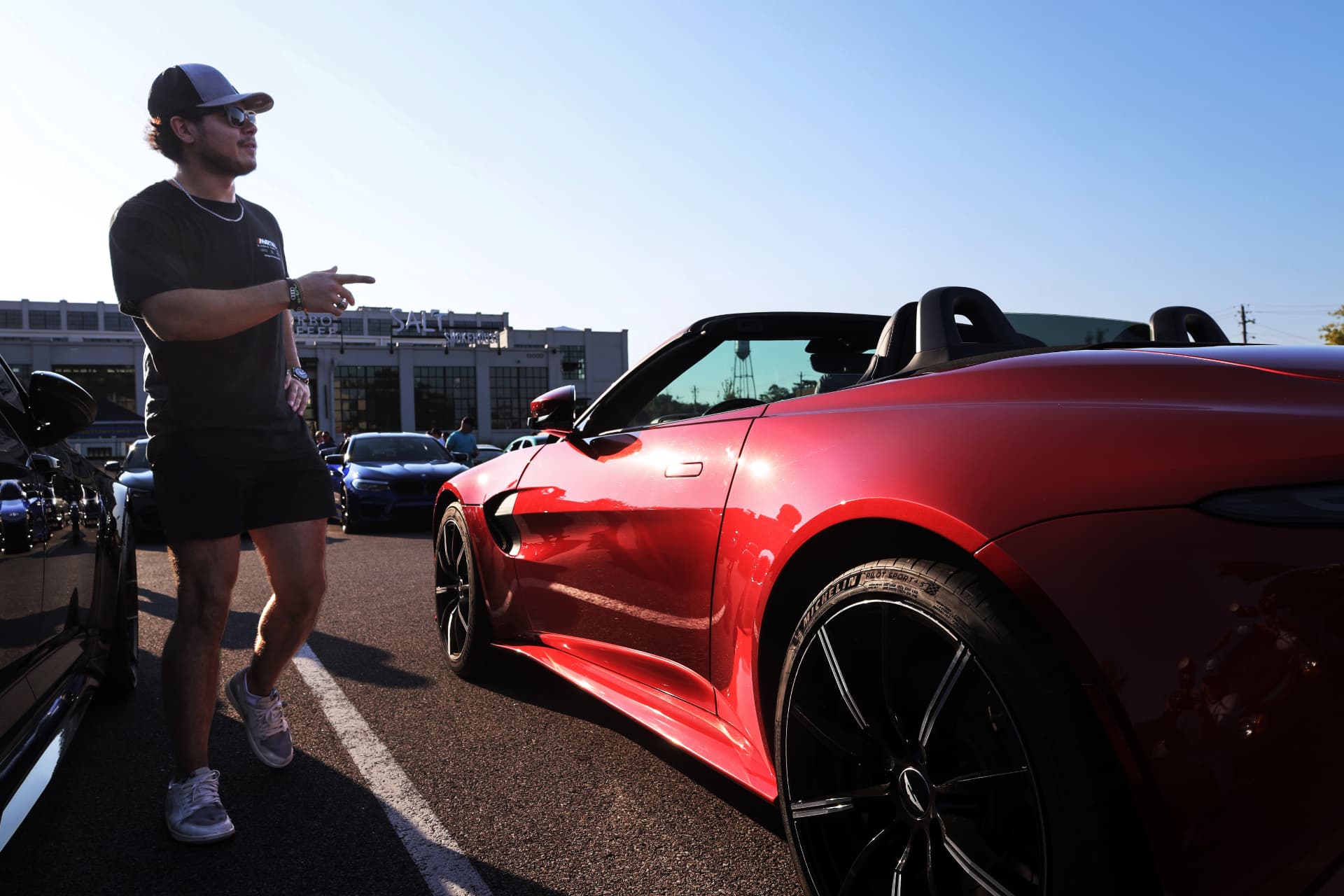 Profile of a red Toyota Supra convertible in afternoon light at a car meet