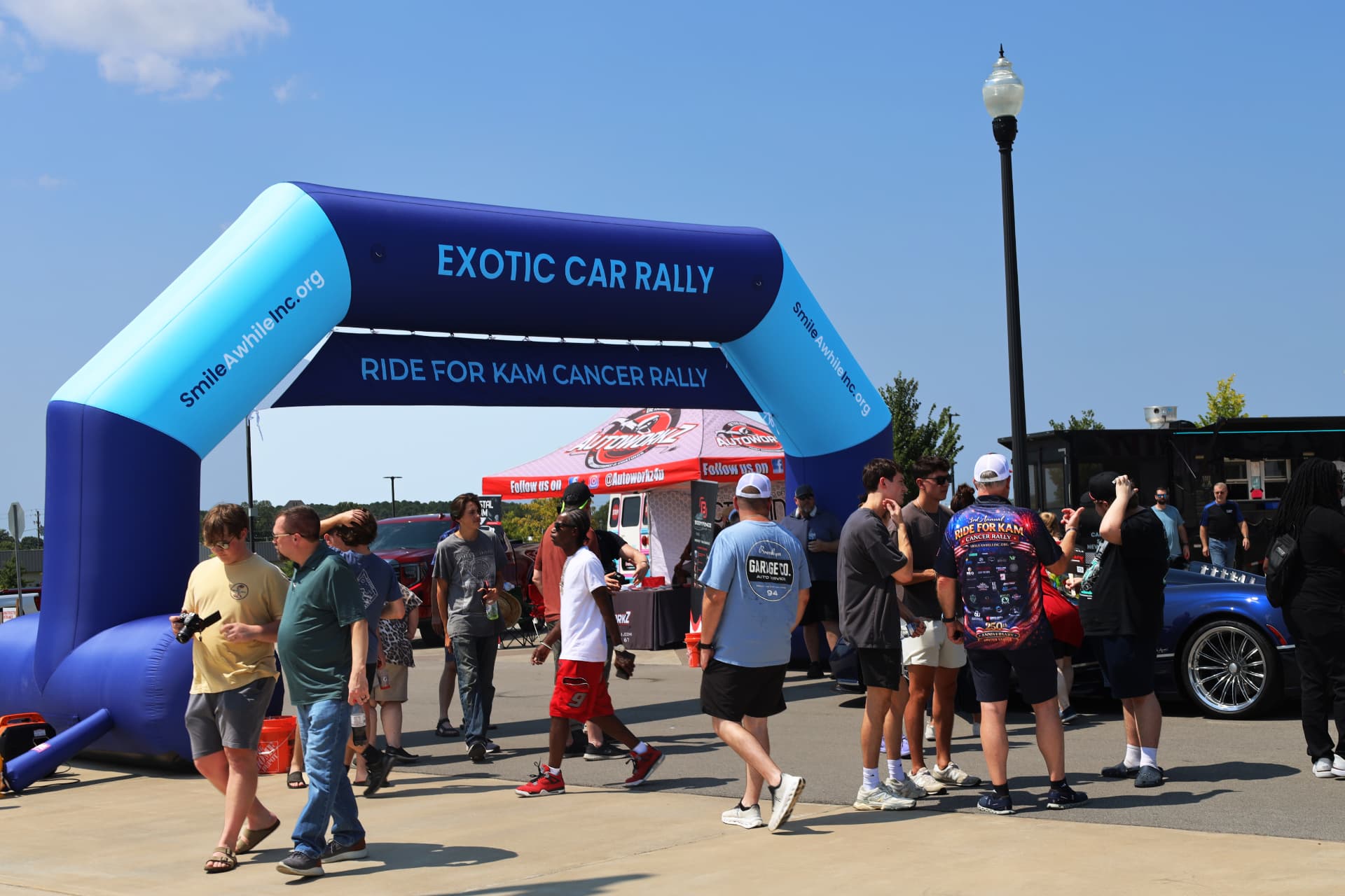 Exotic Car Rally Ride for Kam Cancer inflatable arch and crowd