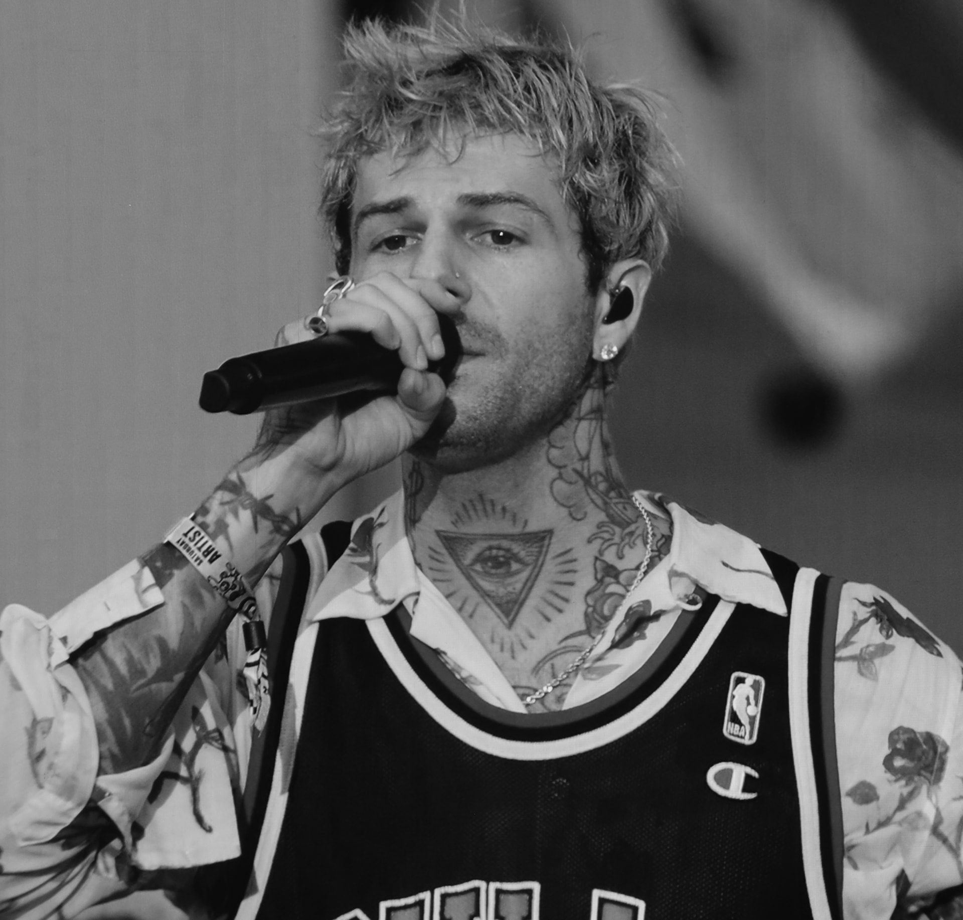 Black and white close portrait of a vocalist performing with a microphone