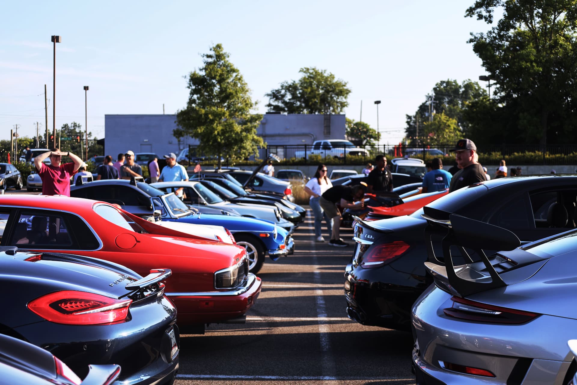 Colorful supercars and classics lined up at a cars and coffee meet