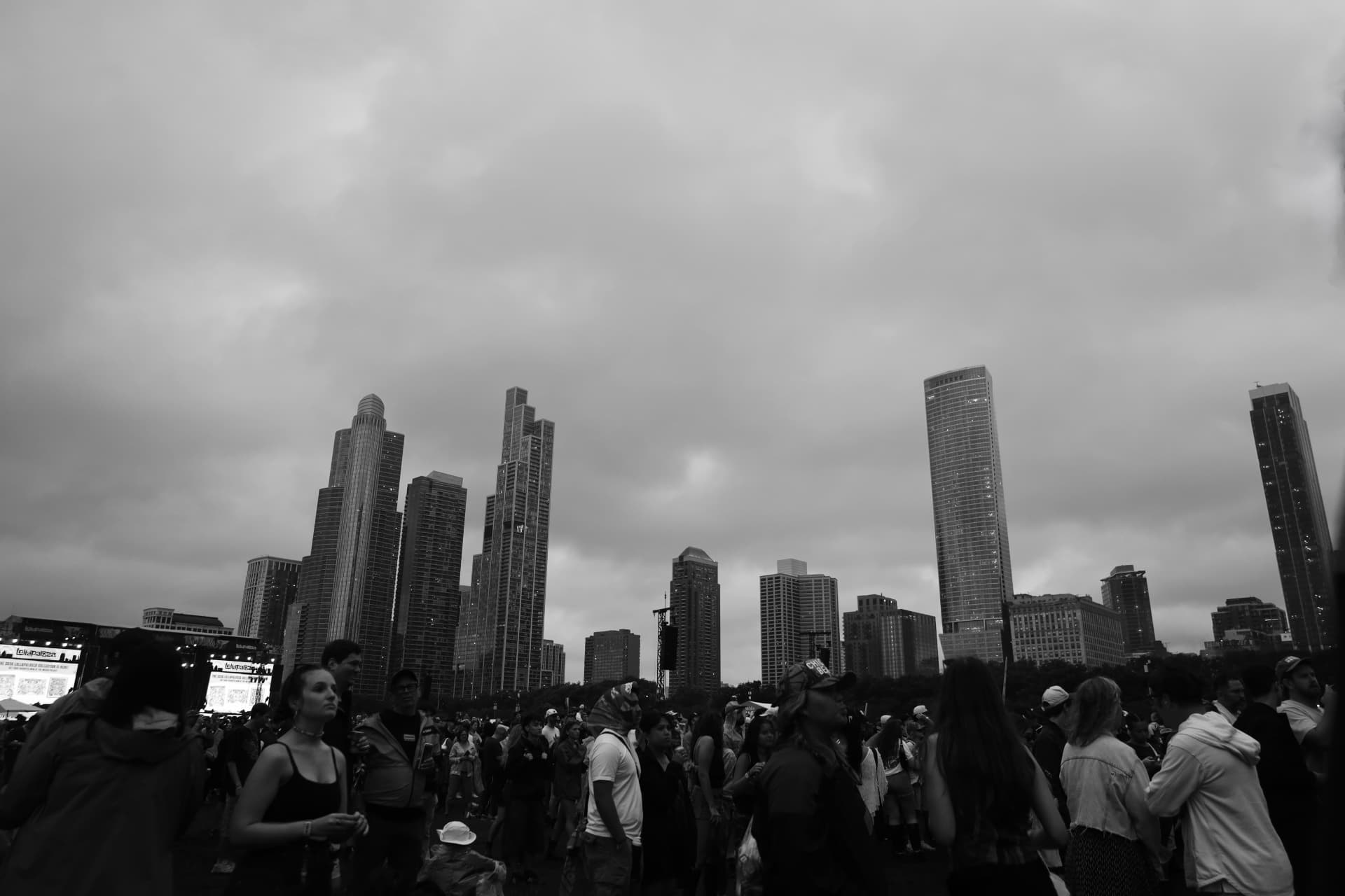 Black and white crowd with the Chicago skyline under overcast skies